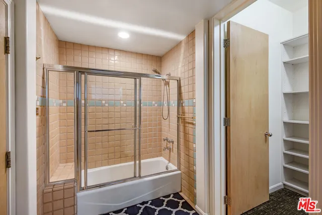 a bathroom with a shower and a glass door