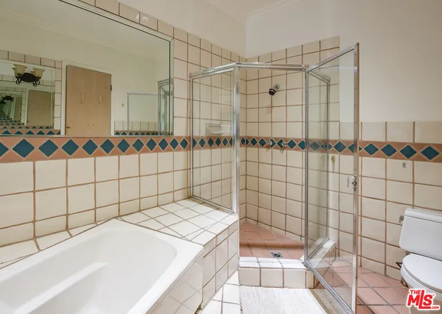 a bathroom with a bathtub and shower