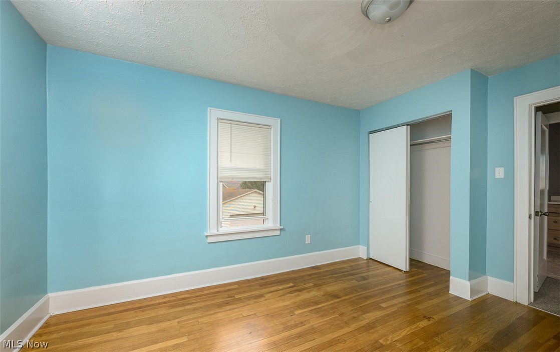1222 Ridge Road Northwest Canton, OH 44703 - Photo 19 of 32 Upstairs bedroom with multiple windows and wood flooring