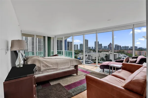 a bedroom with a bed a couch and a window