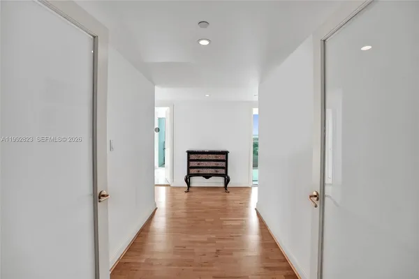 a bedroom with a bed and glass window