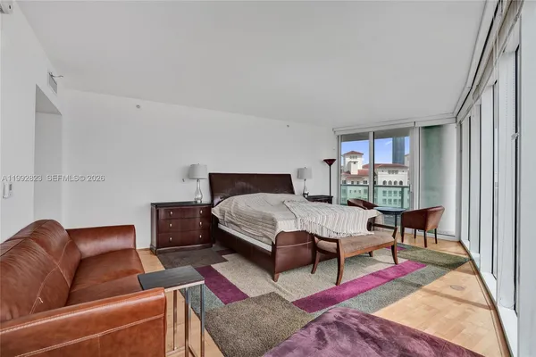 a living room with furniture and a floor to ceiling window