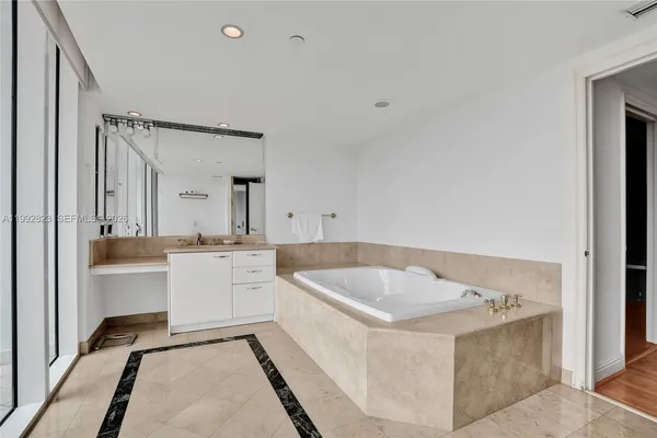 a bed room with a bed and mirror