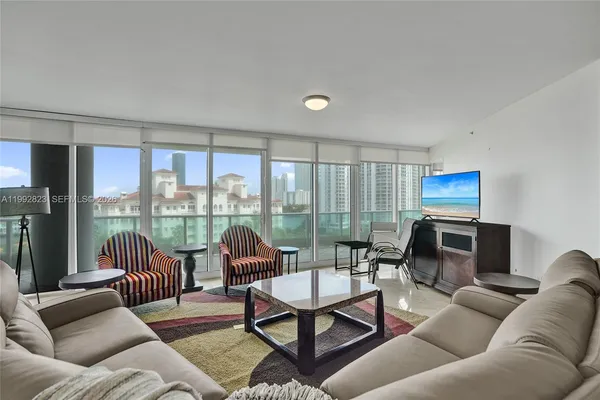 a view of living room with furniture and chandelier