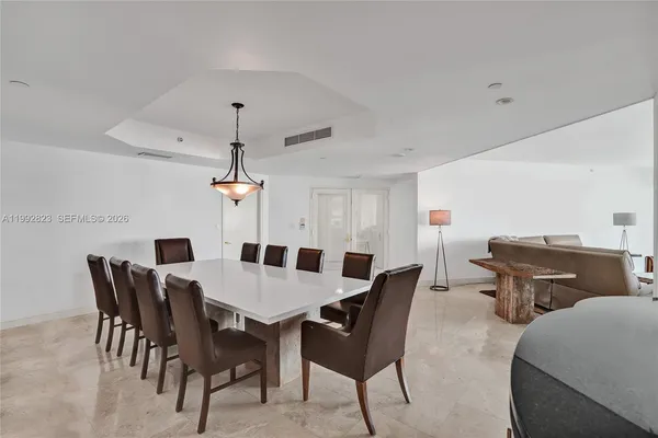 a kitchen with stainless steel appliances kitchen island granite countertop a table and chairs in it