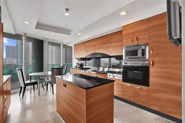 a kitchen with stainless steel appliances granite countertop a refrigerator and a stove