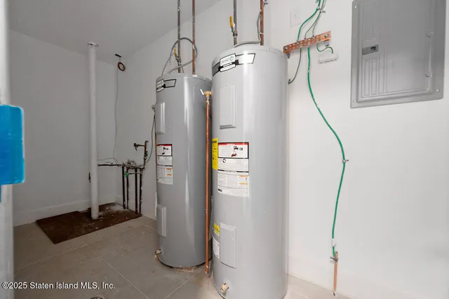 a view of a hallway to a livingroom with wooden floor and windows