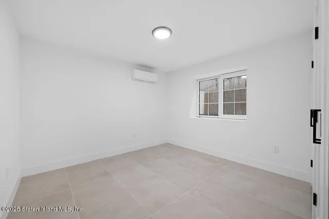 a front view of a house with a small yard and potted plants