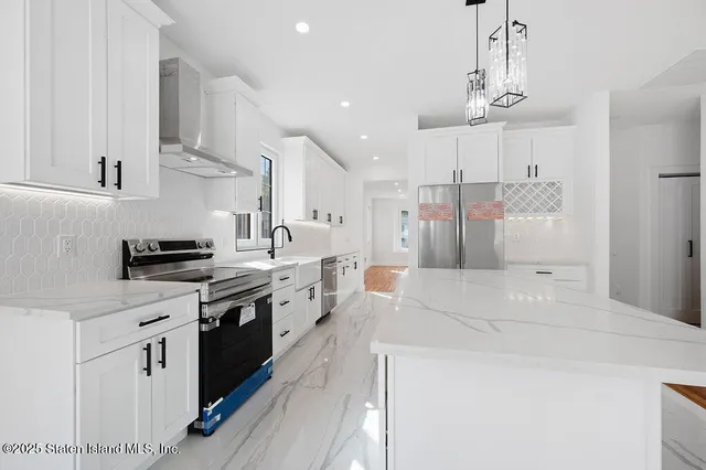 a large kitchen with stainless steel appliances kitchen island granite countertop a sink and cabinets