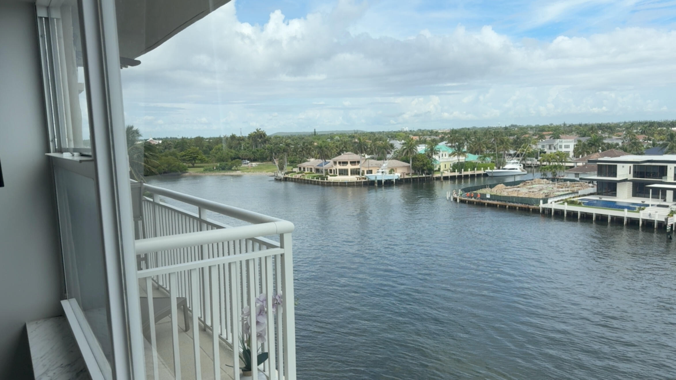 2611 North Riverside Drive, Unit 703 Pompano Beach, FL 33062 - Photo 76 of 81 a view of a lake with boats and trees in the background