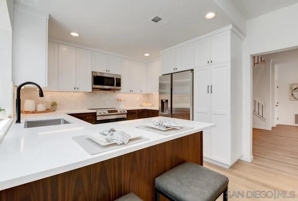 721 Summersong Lane Encinitas, CA 92024 - Photo 11 of 29 a kitchen with a refrigerator a stove a sink and a microwave