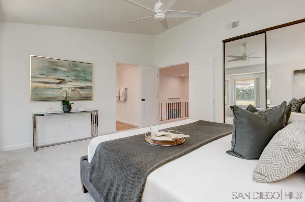 721 Summersong Lane Encinitas, CA 92024 - Photo 20 of 29 a bedroom with a bed and a couch