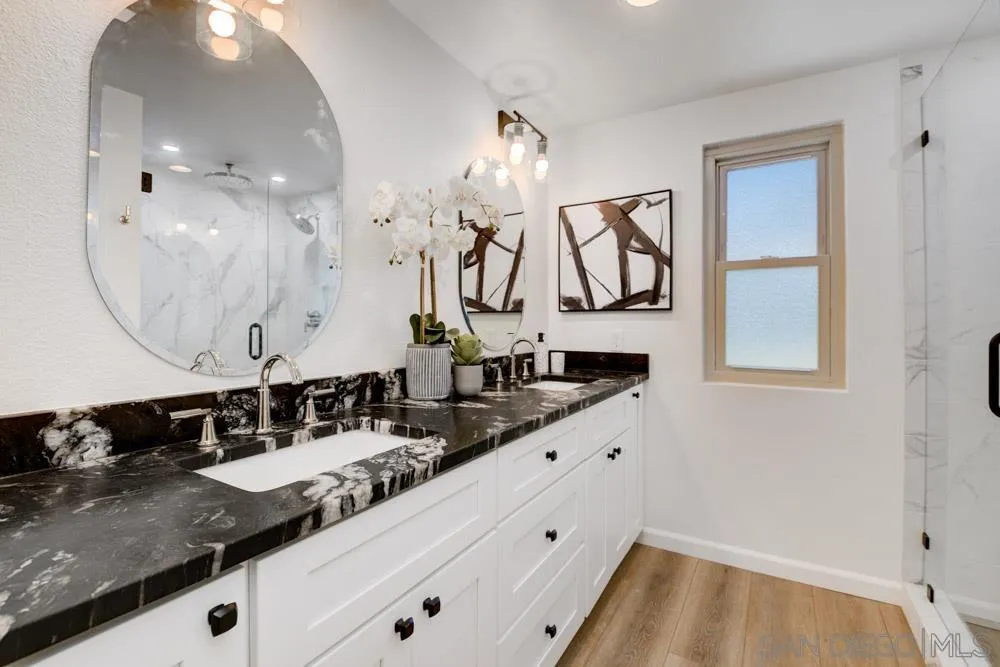 721 Summersong Lane Encinitas, CA 92024 - Photo 21 of 29 a bathroom with a double vanity sink and mirror