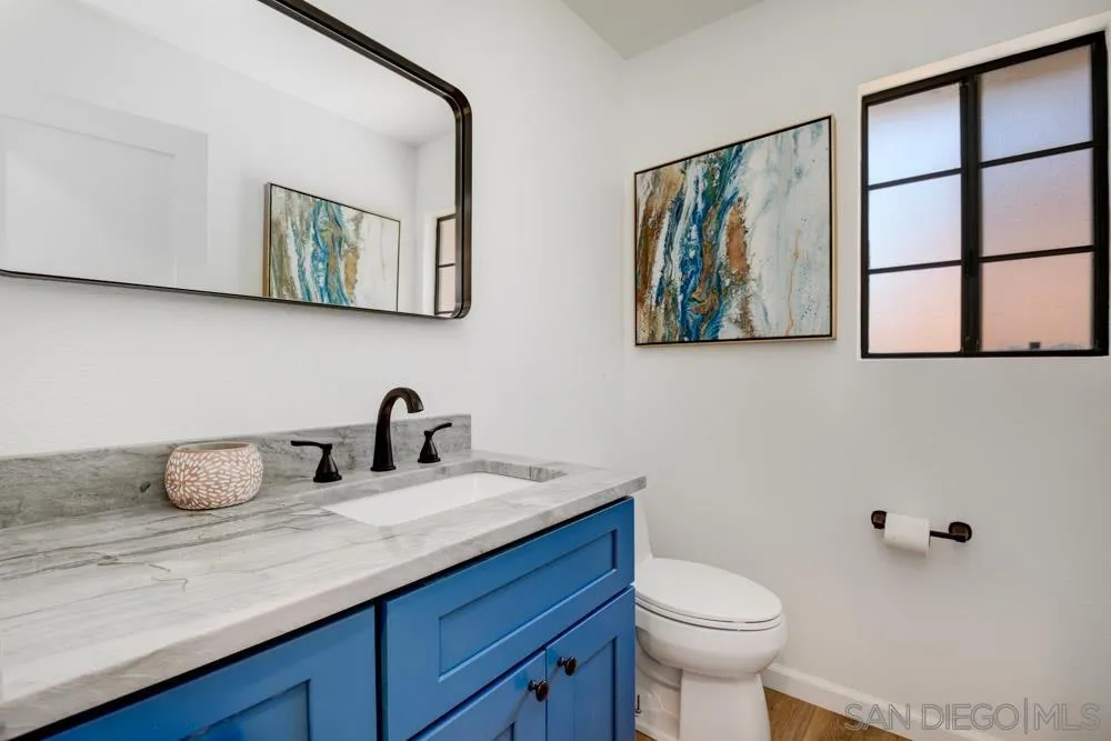 721 Summersong Lane Encinitas, CA 92024 - Photo 25 of 29 a bathroom with a toilet a sink and mirror
