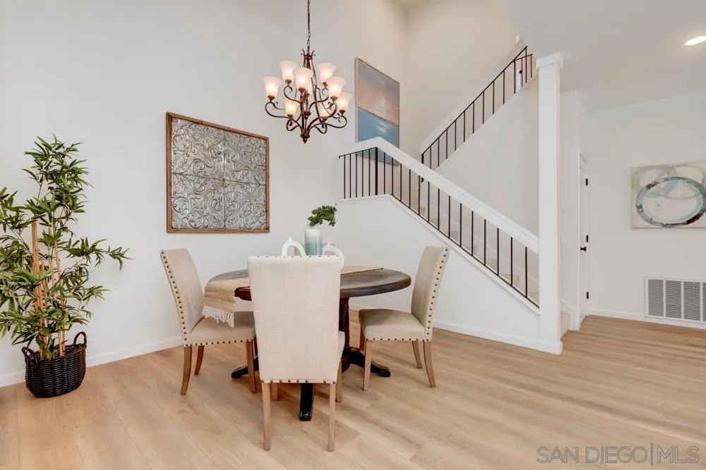 721 Summersong Lane Encinitas, CA 92024 - Photo 6 of 29 a view of a dining room with furniture and wooden floor