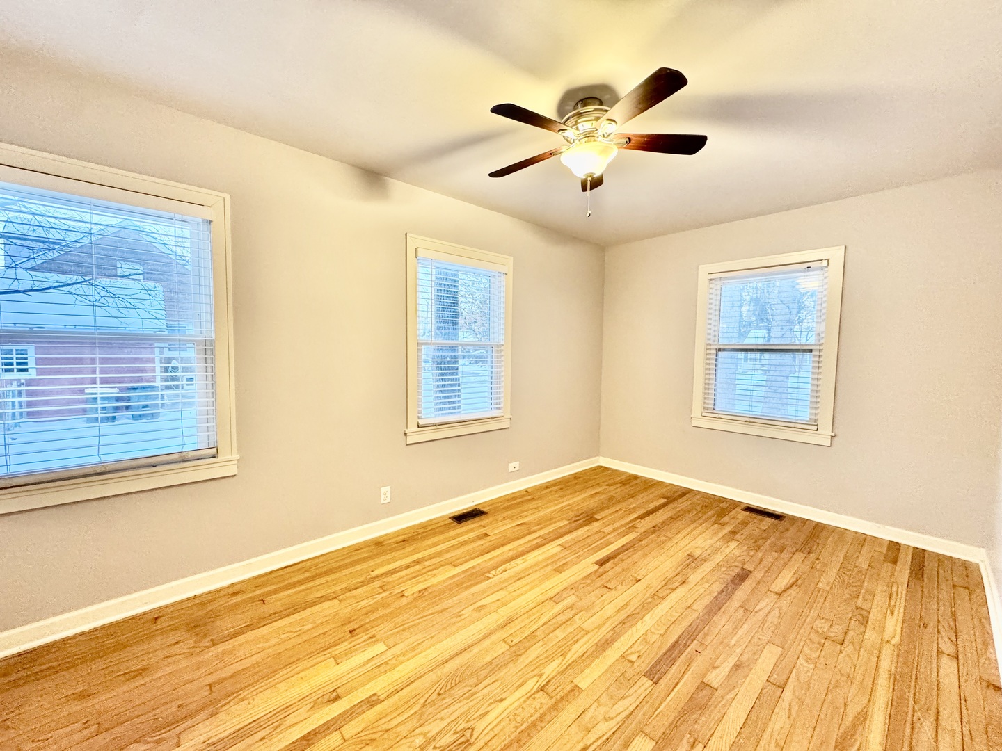 28 Batavia Road Warrenville, IL 60555 - Photo 5 of 17 a view of an empty room with wooden floor and a window