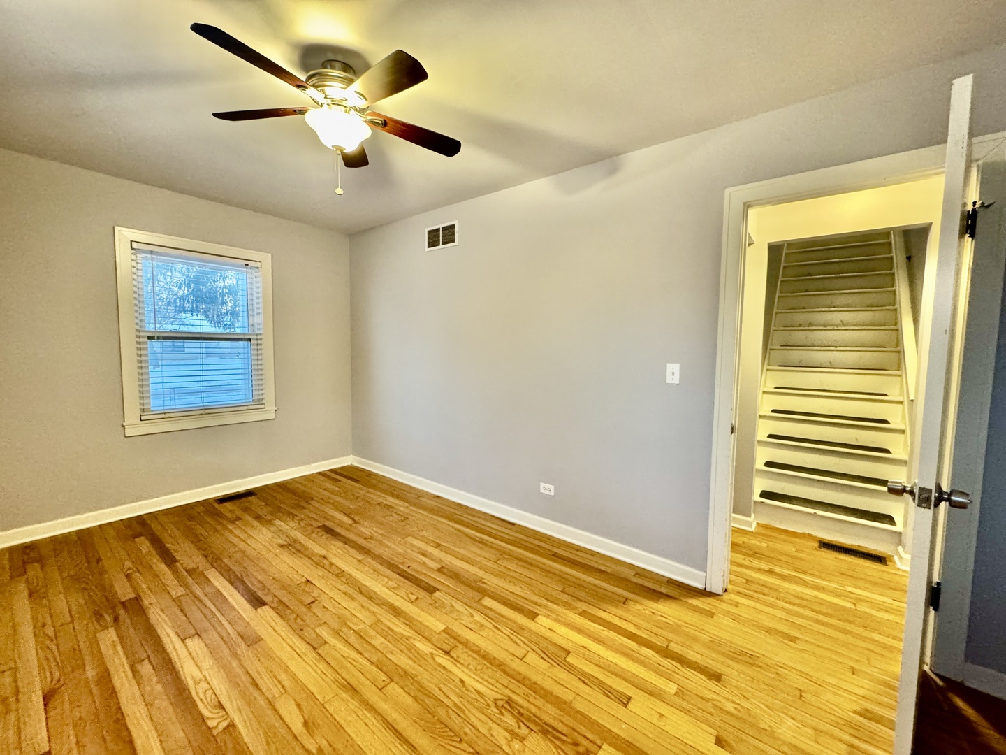 28 Batavia Road Warrenville, IL 60555 - Photo 6 of 17 a view of an empty room with wooden floor and a window