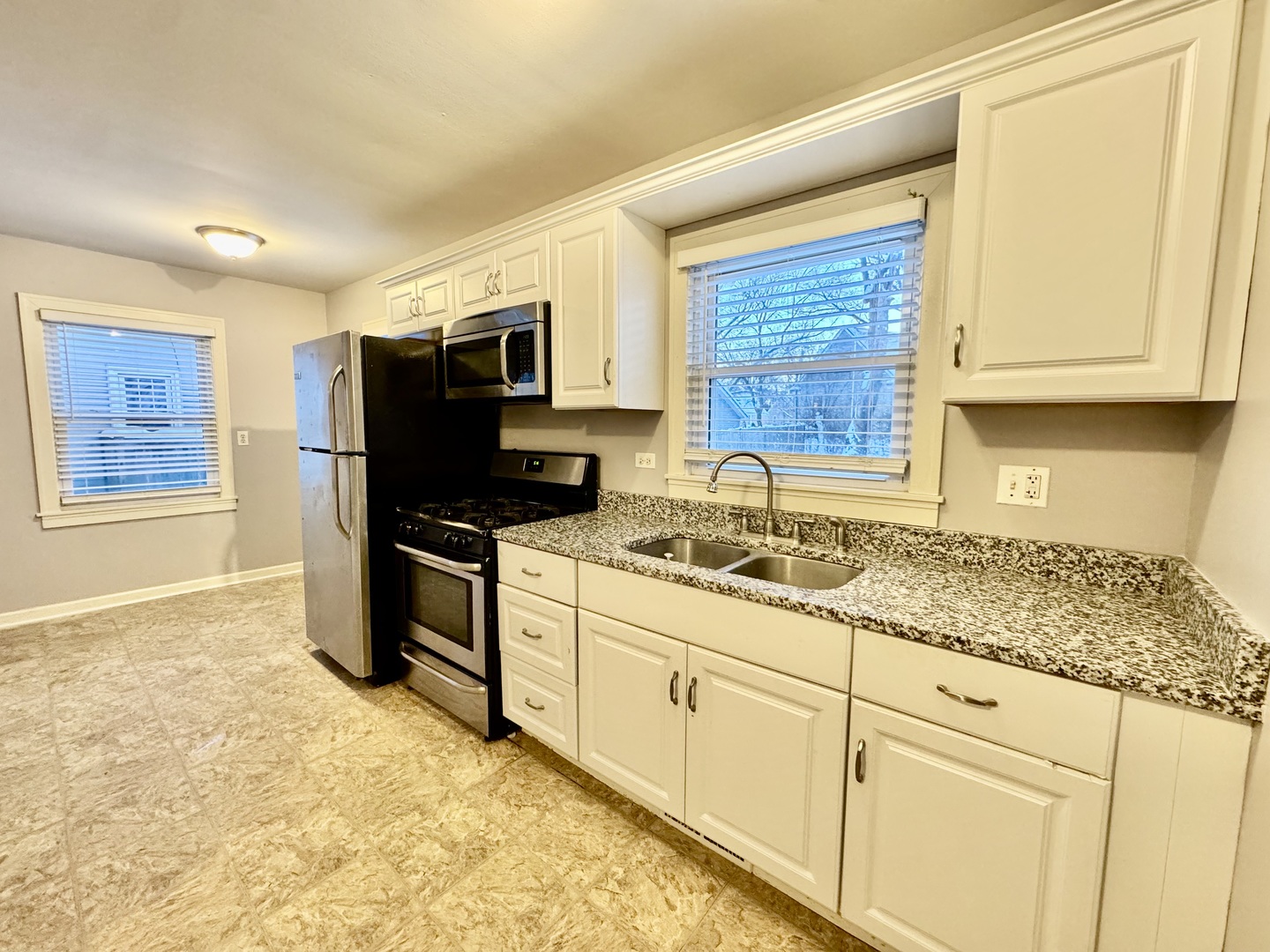 28 Batavia Road Warrenville, IL 60555 - Photo 8 of 17 a kitchen with granite countertop a sink cabinets and stainless steel appliances