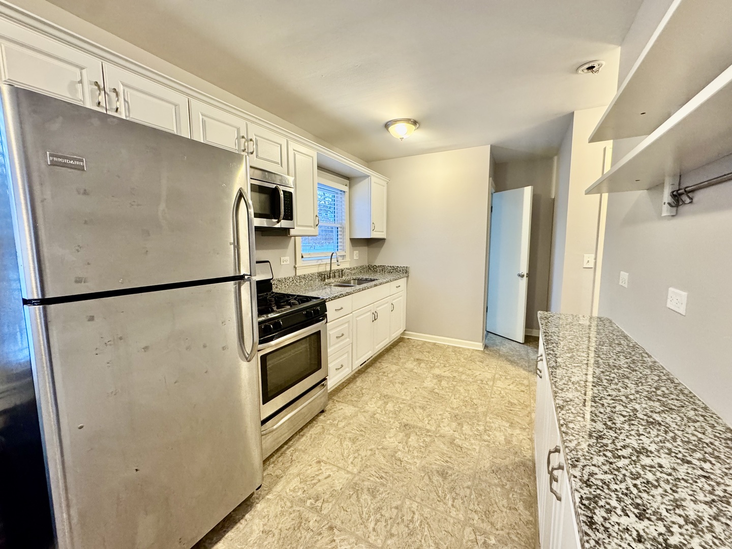28 Batavia Road Warrenville, IL 60555 - Photo 9 of 17 a kitchen with stainless steel appliances a refrigerator a stove a microwave and cabinets