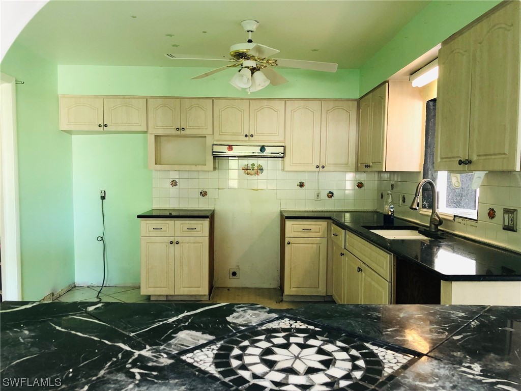 2701 W Road Fort Myers, FL 33905 - Photo 17 of 50 a kitchen with a sink and a stove top oven