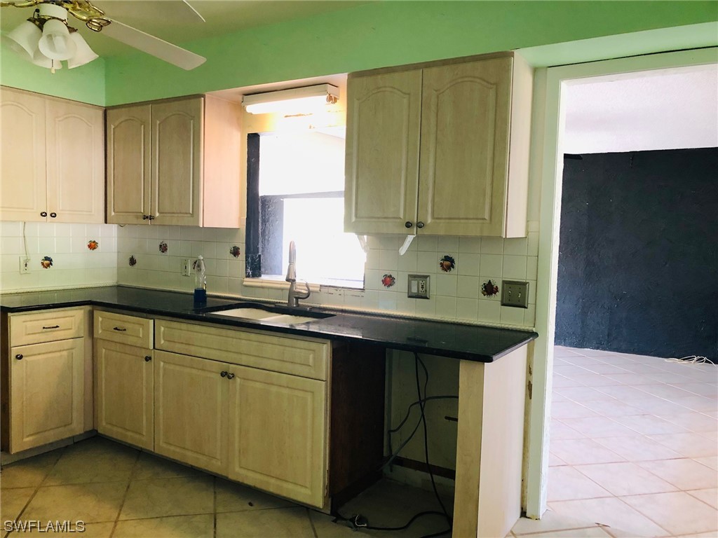 2701 W Road Fort Myers, FL 33905 - Photo 19 of 50 a kitchen with a sink and cabinets