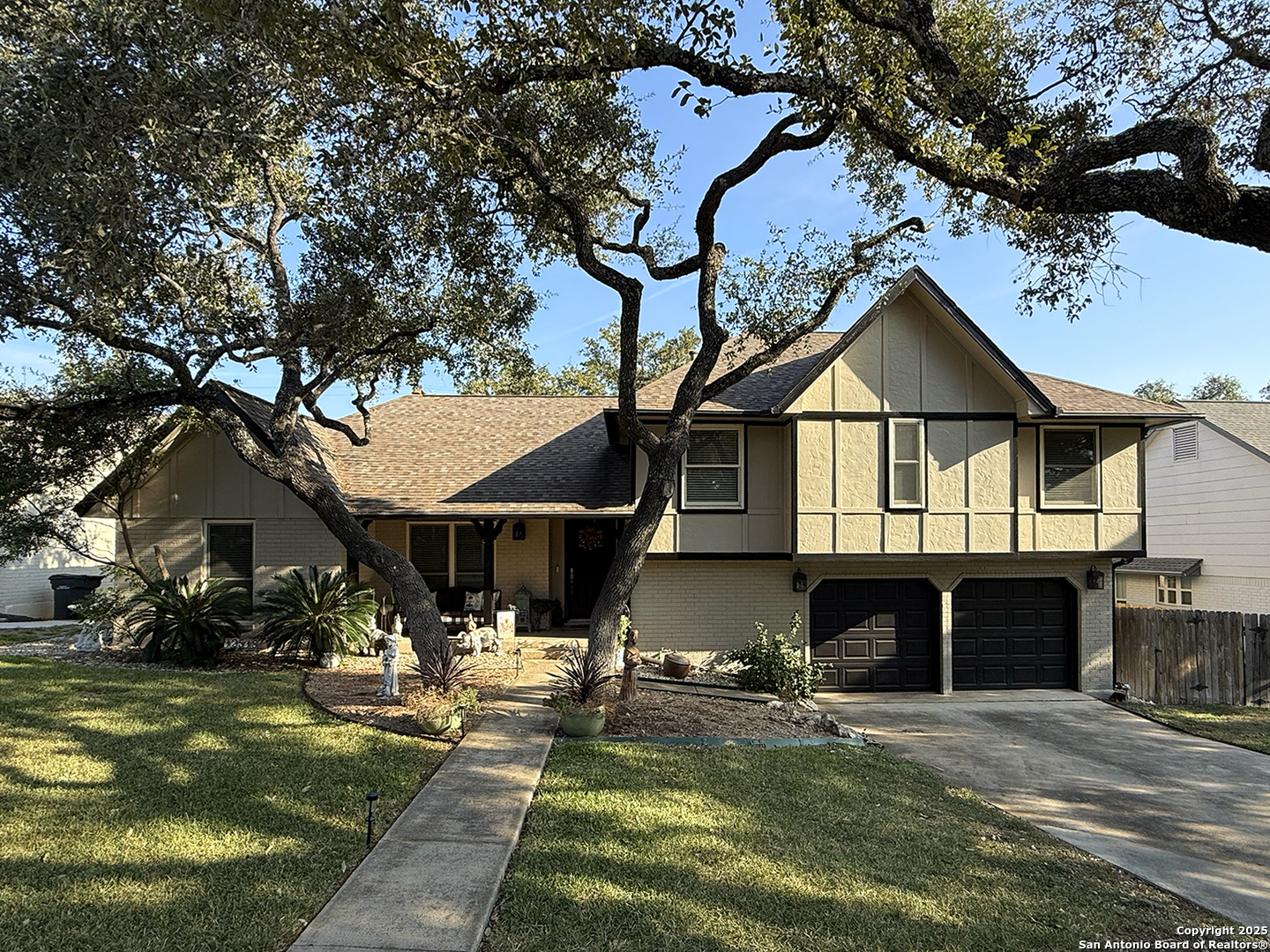 12518 Chateau Forest Lane San Antonio, TX 78230 - Photo 1 of 37 a front view of a house with a yard table and chairs