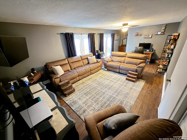 a living room with furniture a rug and a flat screen tv