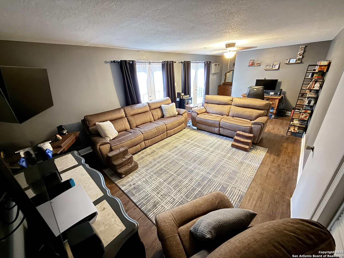 12518 Chateau Forest Lane San Antonio, TX 78230 - Photo 12 of 37 a living room with furniture a rug and a flat screen tv