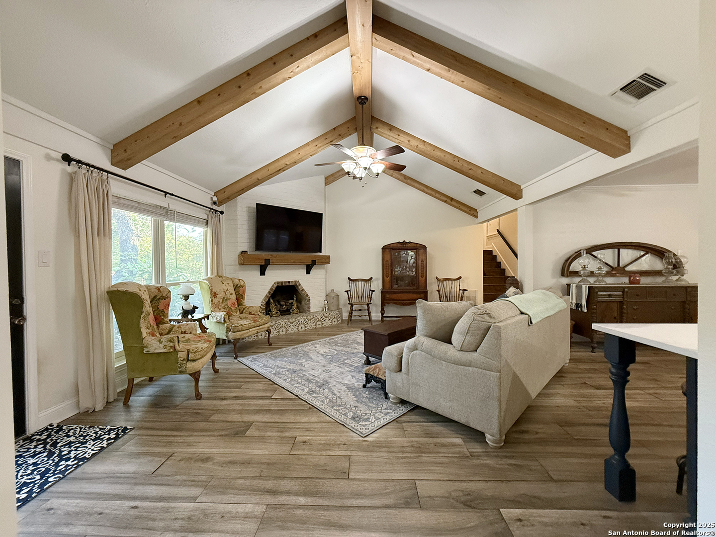12518 Chateau Forest Lane San Antonio, TX 78230 - Photo 21 of 37 a living room with furniture a fireplace and a flat screen tv