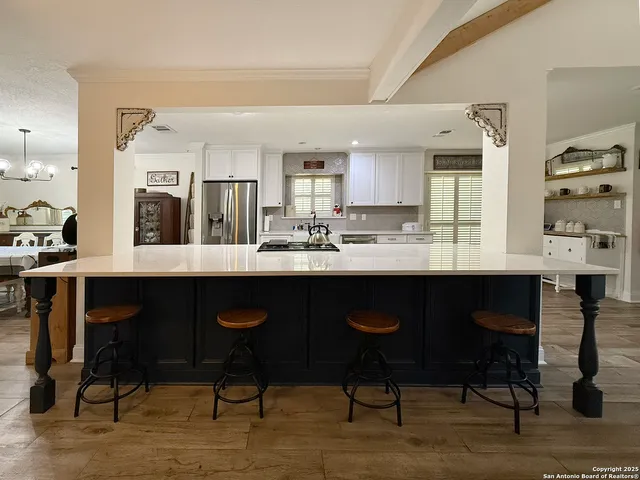 a kitchen with stainless steel appliances granite countertop a stove and a sink