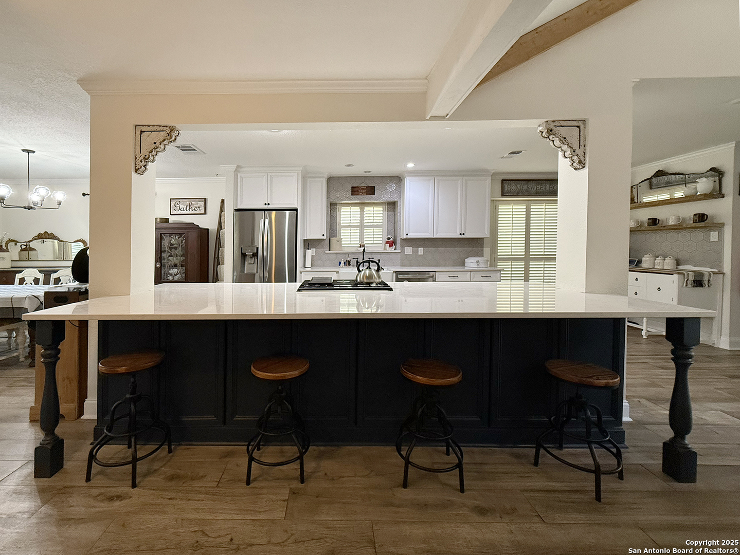 12518 Chateau Forest Lane San Antonio, TX 78230 - Photo 26 of 37 a kitchen with granite countertop a table chairs sink and cabinets