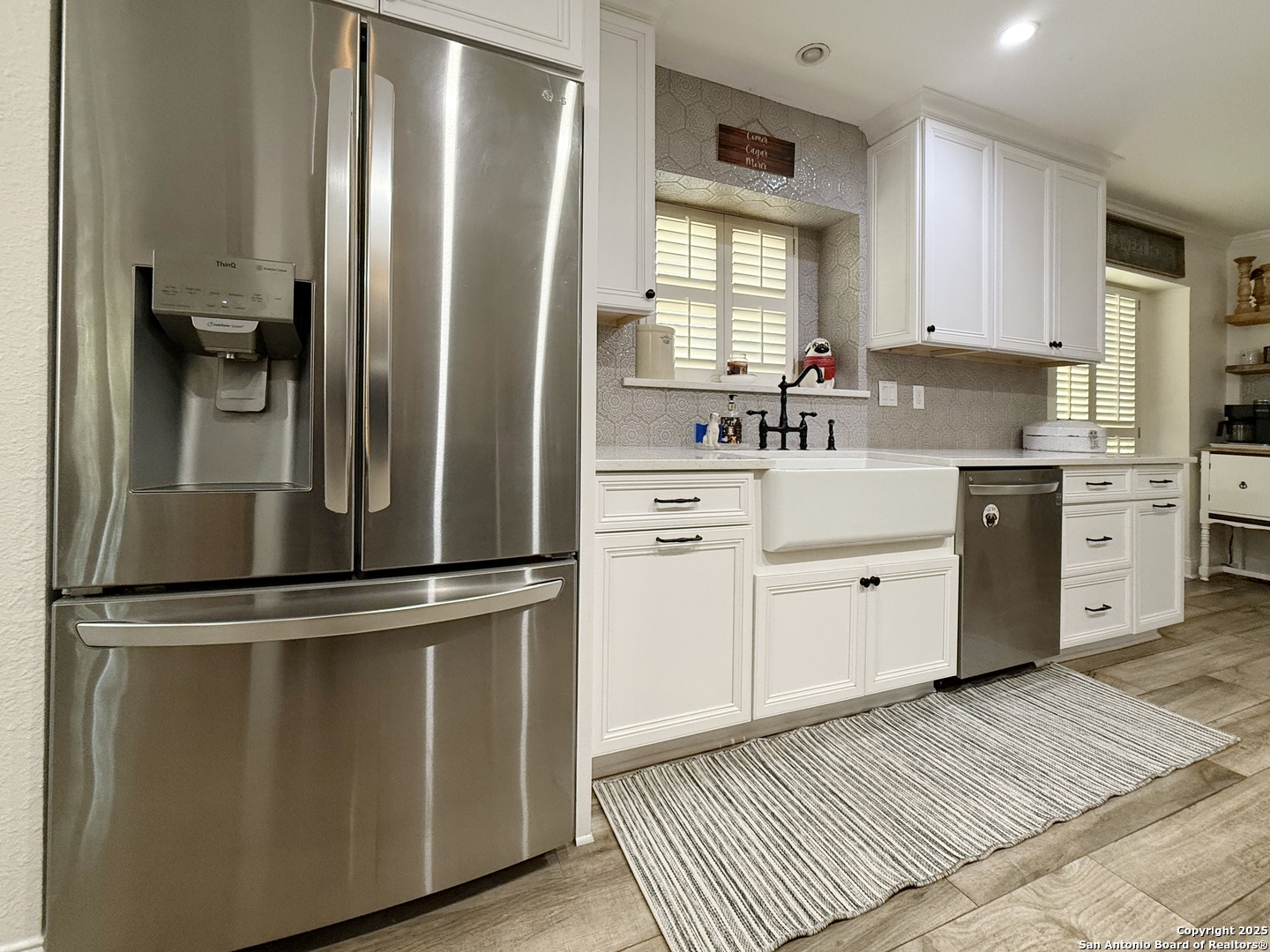 12518 Chateau Forest Lane San Antonio, TX 78230 - Photo 27 of 37 a kitchen with cabinets and stainless steel appliances