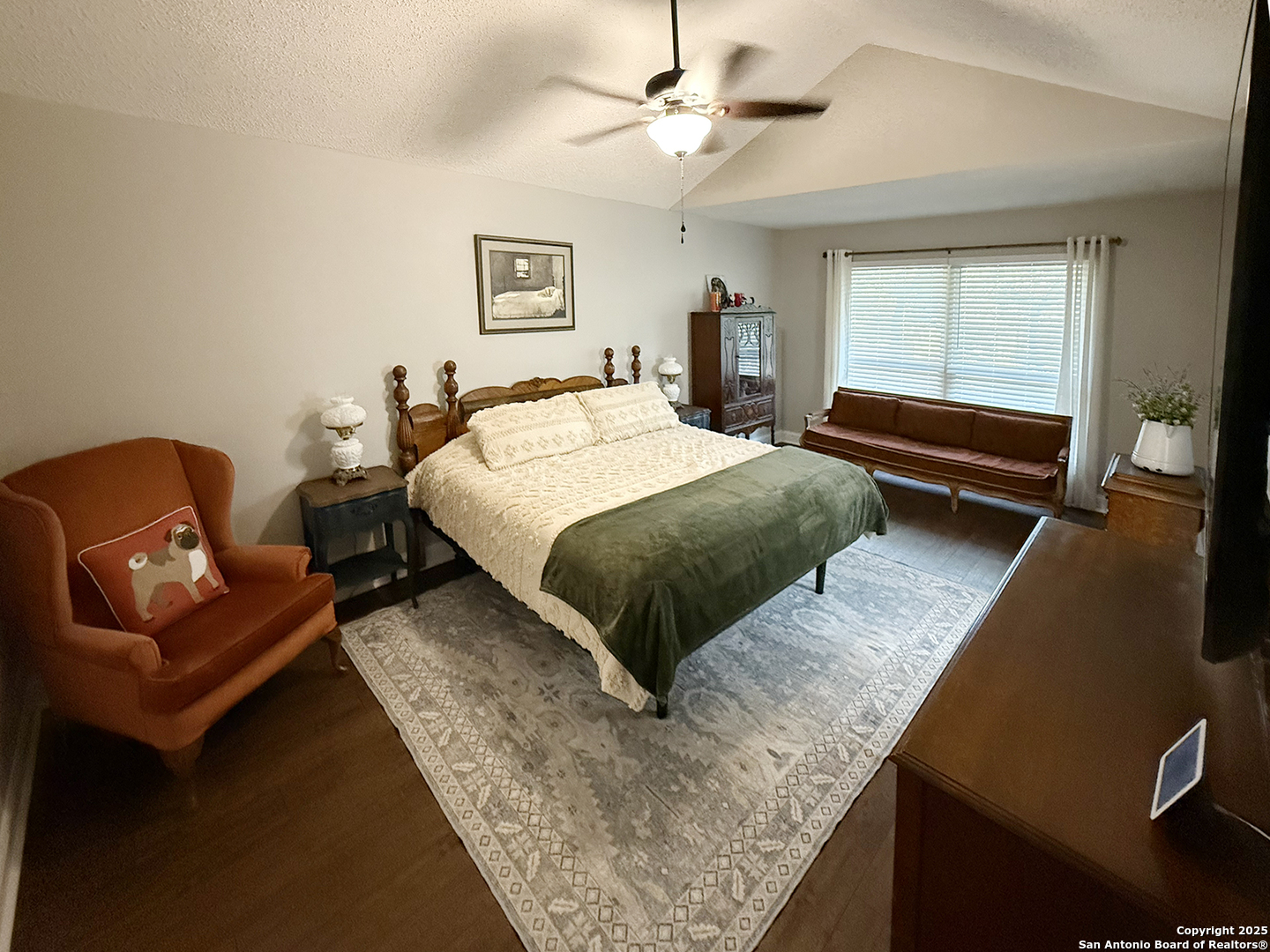 12518 Chateau Forest Lane San Antonio, TX 78230 - Photo 35 of 37 a bedroom with a bed a couch and window