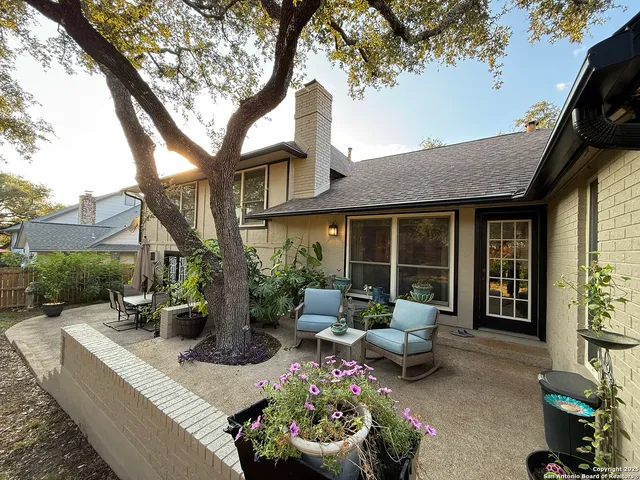 a view of a house with backyard sitting area and garden