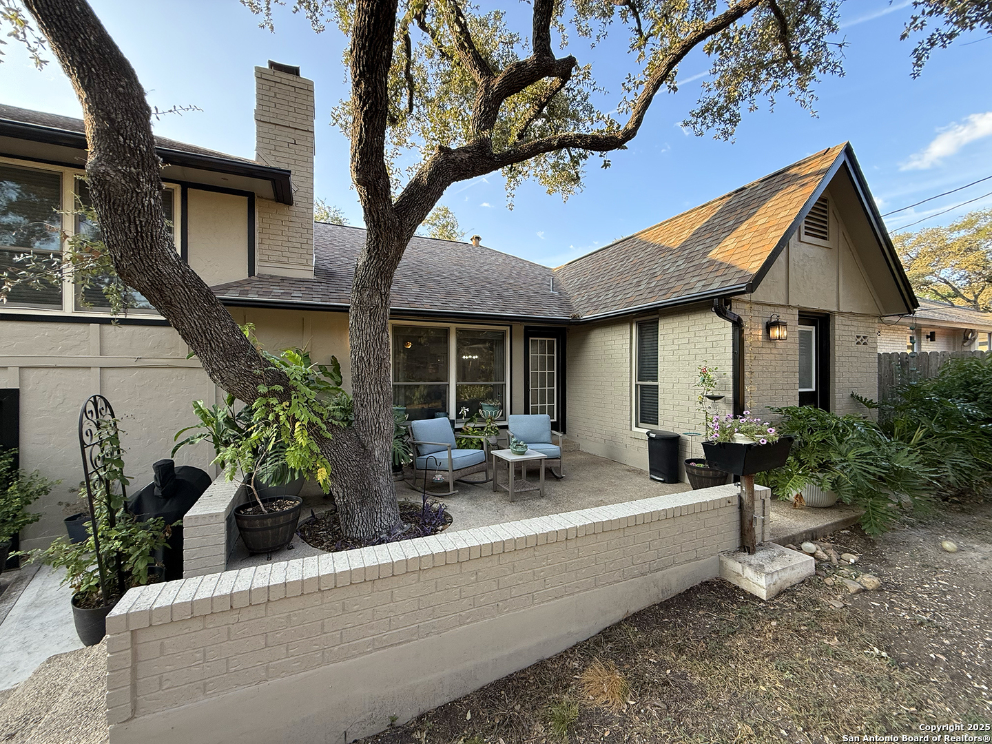 12518 Chateau Forest Lane San Antonio, TX 78230 - Photo 10 of 37 a house outdoor space with patio furniture and potted plants