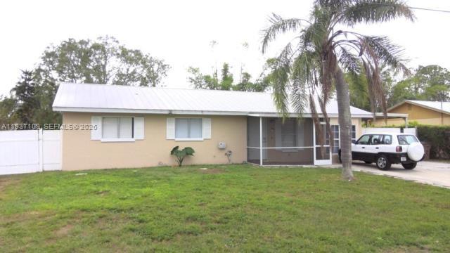 3917-4 4th Street West Lehigh Acres, FL 33971 - Photo 1 of 9 a front view of a house with a garden and trees