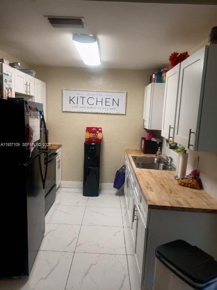 3917-4 4th Street West Lehigh Acres, FL 33971 - Photo 2 of 9 a kitchen with stainless steel appliances a sink stove and refrigerator