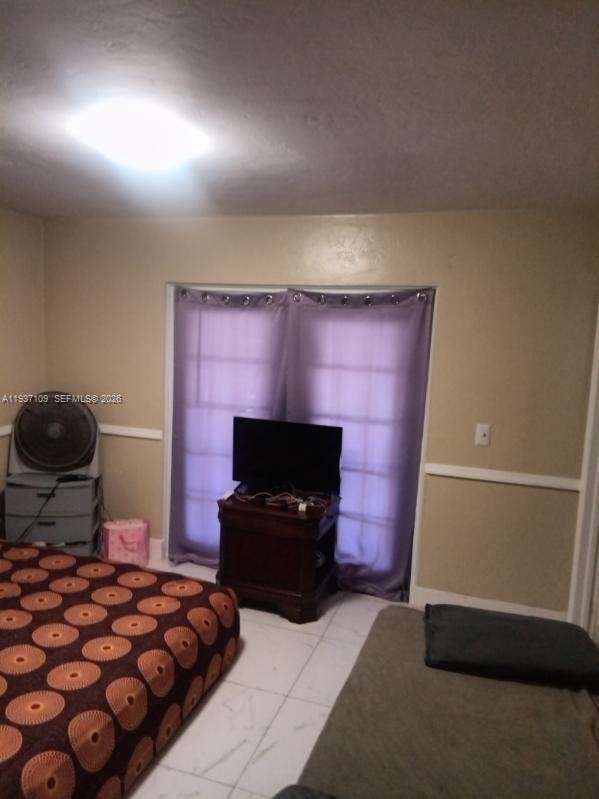 3917-4 4th Street West Lehigh Acres, FL 33971 - Photo 7 of 9 a bedroom with bed and flat screen tv