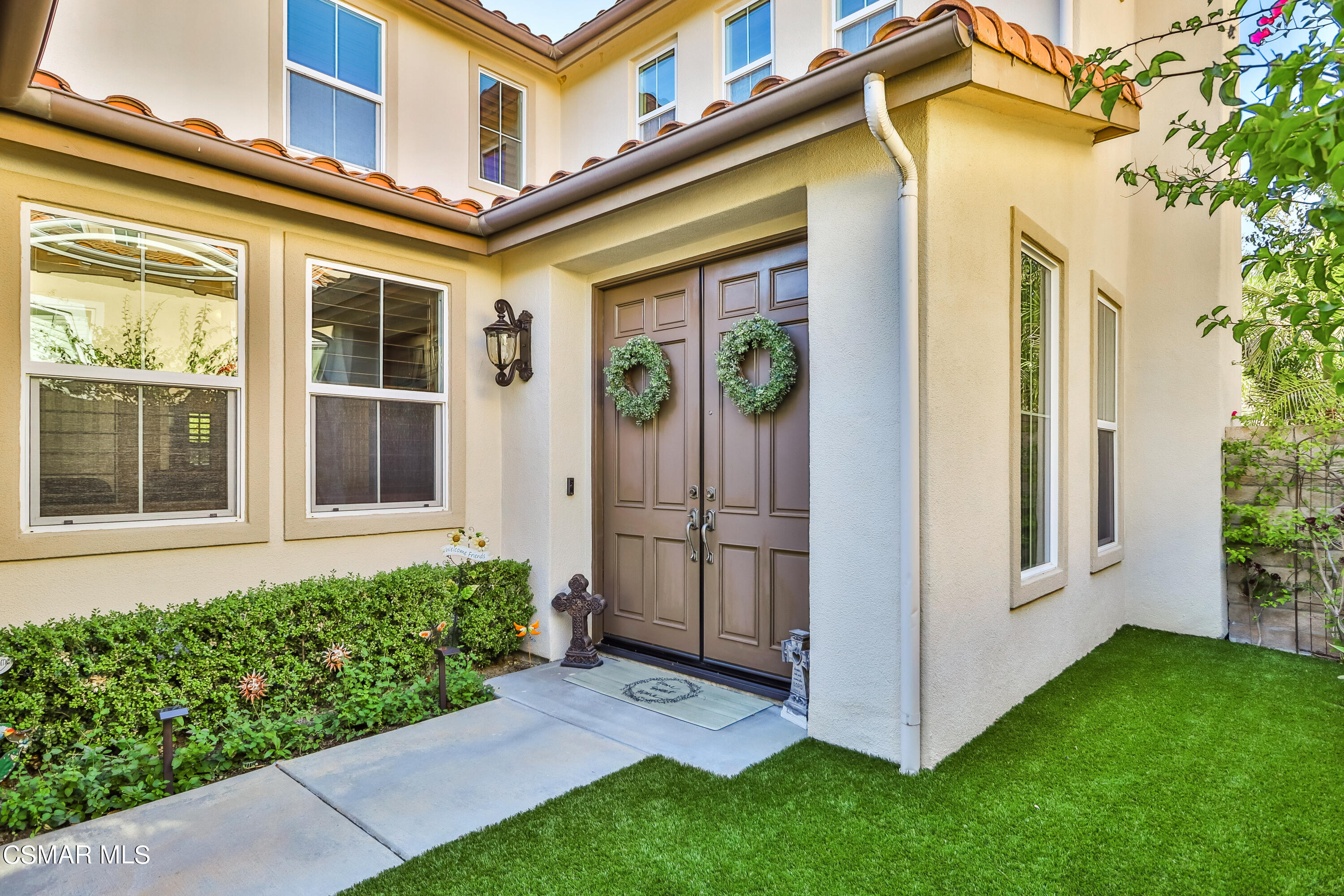 4025 Eagle Flight Drive Simi Valley, CA 93065 - Photo 4 of 60 a view of a house with brick walls and a yard with potted plants