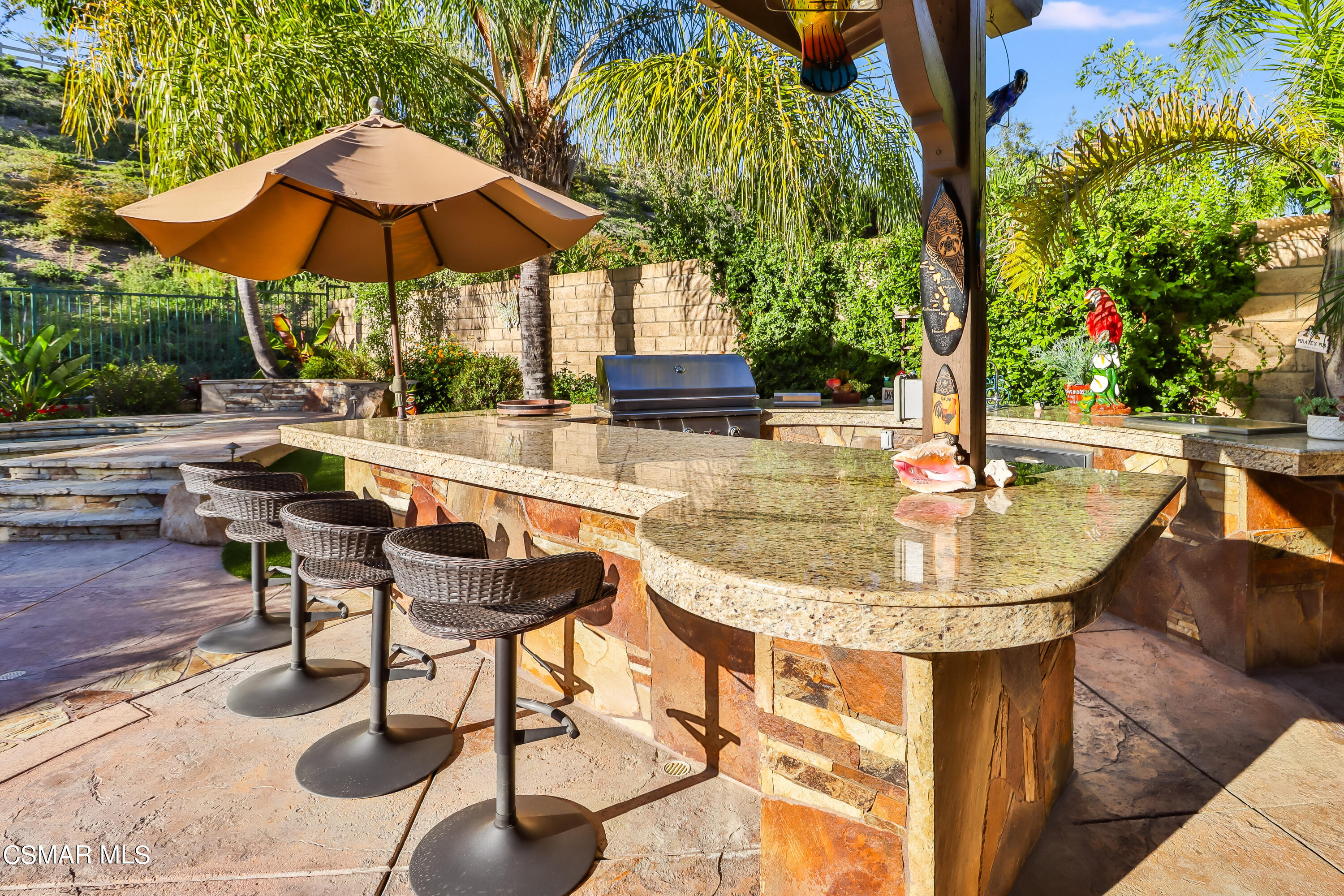 4025 Eagle Flight Drive Simi Valley, CA 93065 - Photo 7 of 60 a view of a swimming pool with a table and chairs under an umbrella