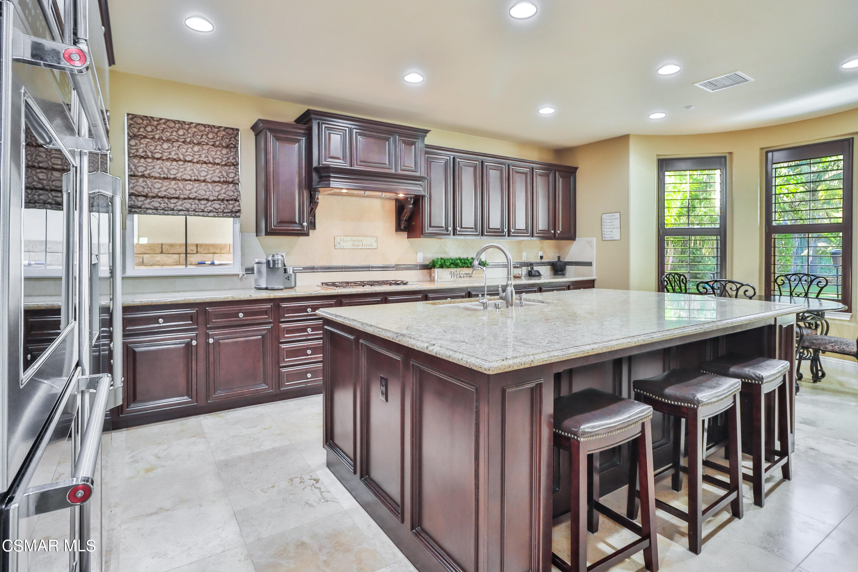 4025 Eagle Flight Drive Simi Valley, CA 93065 - Photo 10 of 60 a kitchen with a stove a sink a center island and a window