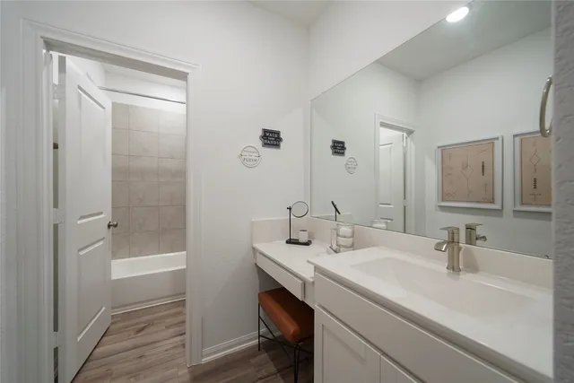 a bathroom with a sink a shower and a mirror