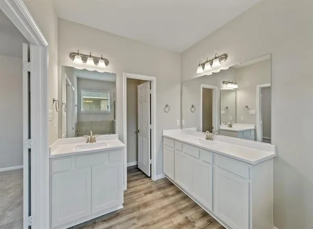a bathroom with a double vanity sink mirror and