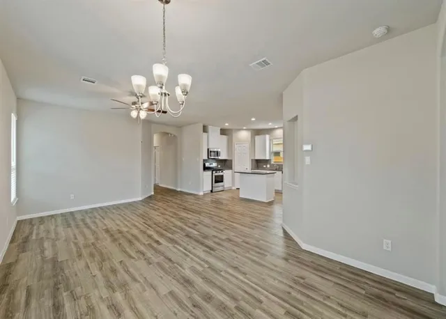 a view of a kitchen with wooden floor and a chandelier