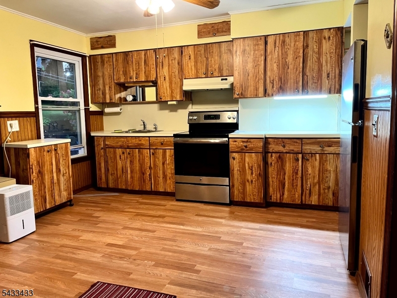 30 Fowler Street Franklin, NJ 07416 - Photo 8 of 27 a kitchen with stainless steel appliances granite countertop a refrigerator a stove top oven a sink and dishwasher with wooden floor