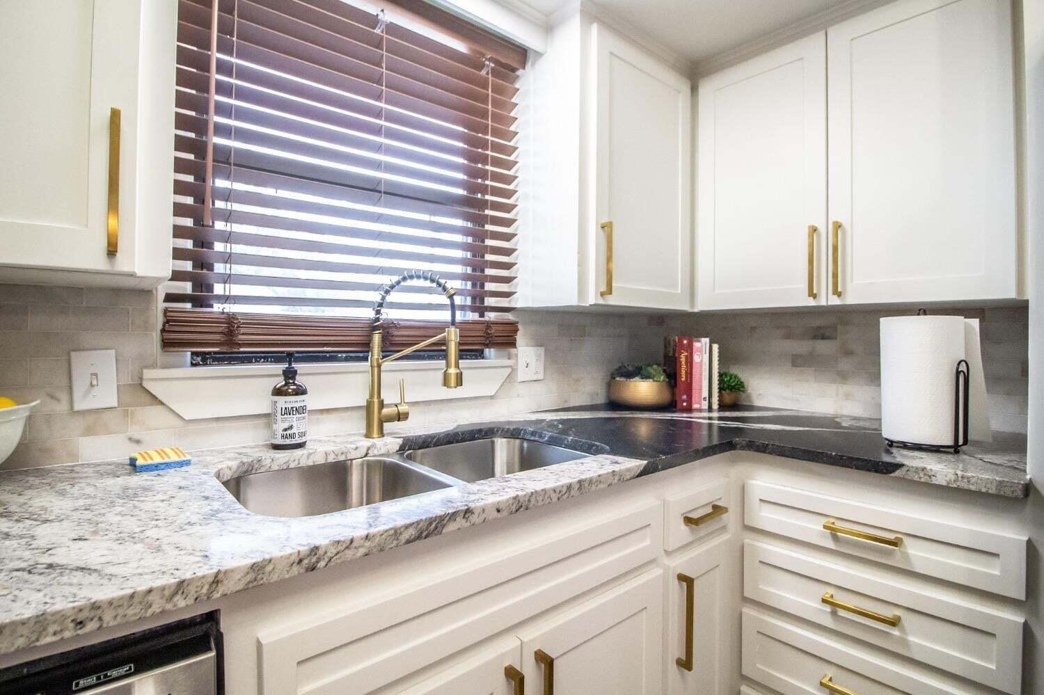3501 33rd Street Lubbock, TX 79410 - Photo 11 of 34 a kitchen with granite countertop a sink and a window