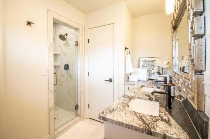 3501 33rd Street Lubbock, TX 79410 - Photo 16 of 34 a large bathroom with a granite countertop tub shower and sink