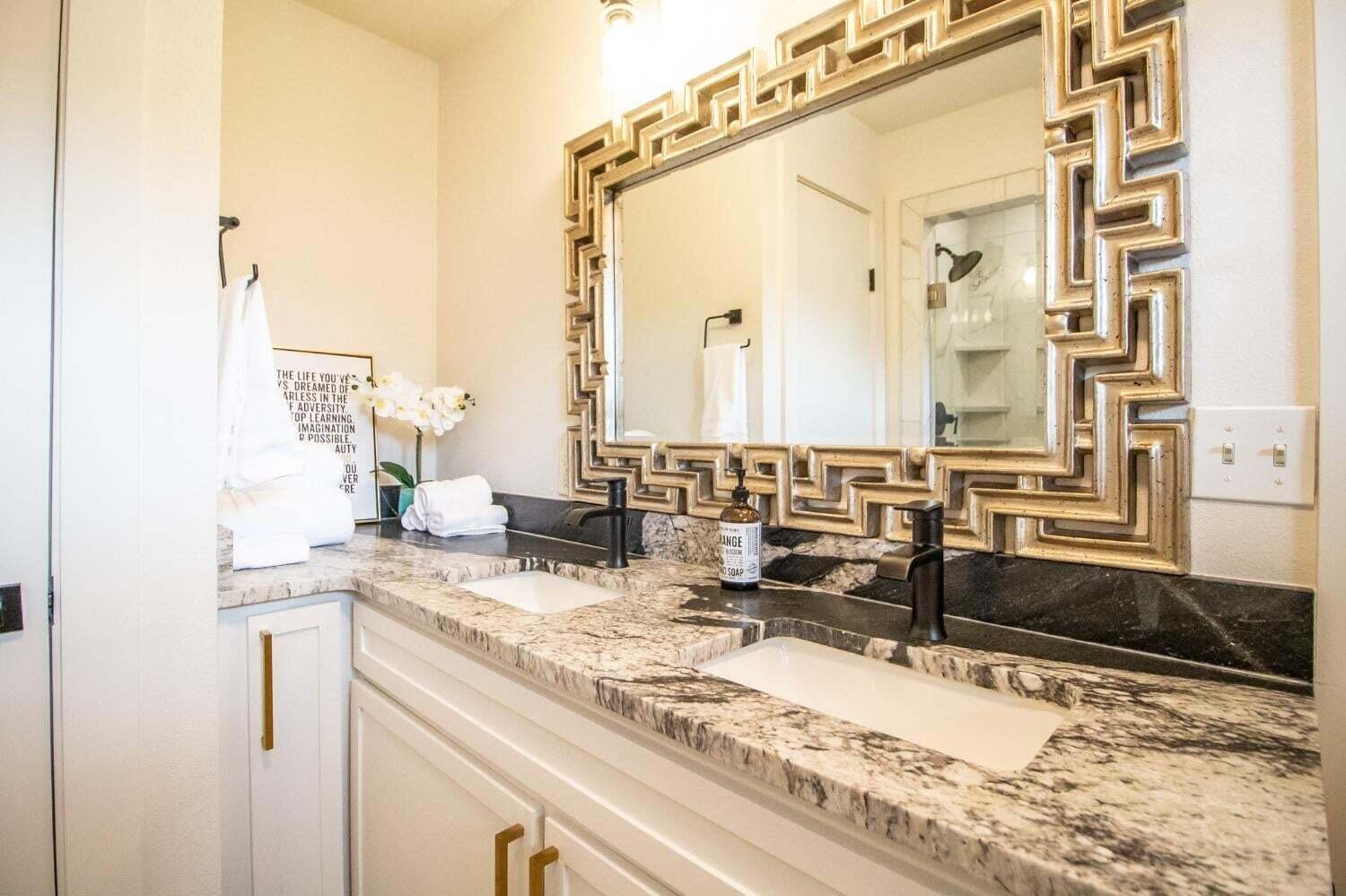 3501 33rd Street Lubbock, TX 79410 - Photo 17 of 34 a bathroom with a granite countertop sink and a mirror