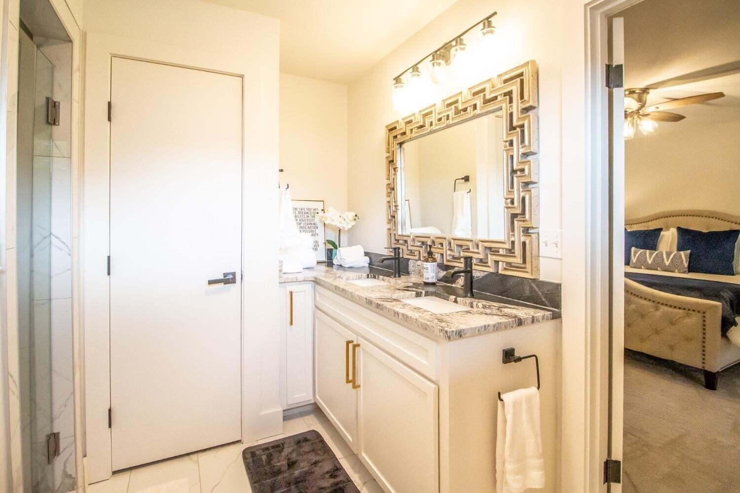 3501 33rd Street Lubbock, TX 79410 - Photo 19 of 34 a bathroom with a sink a mirror and a shower