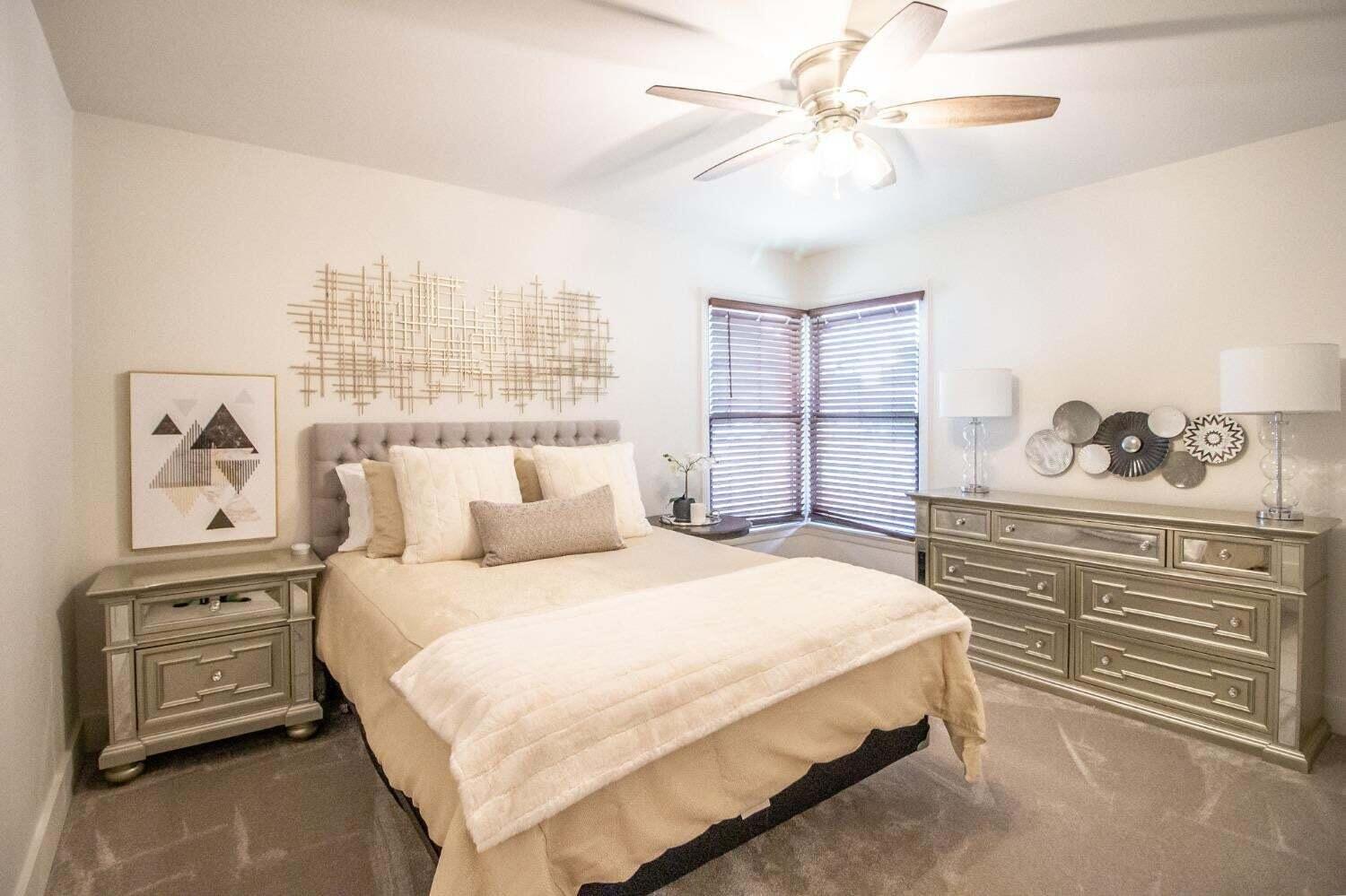 3501 33rd Street Lubbock, TX 79410 - Photo 21 of 34 a bedroom with a bed and a chandelier